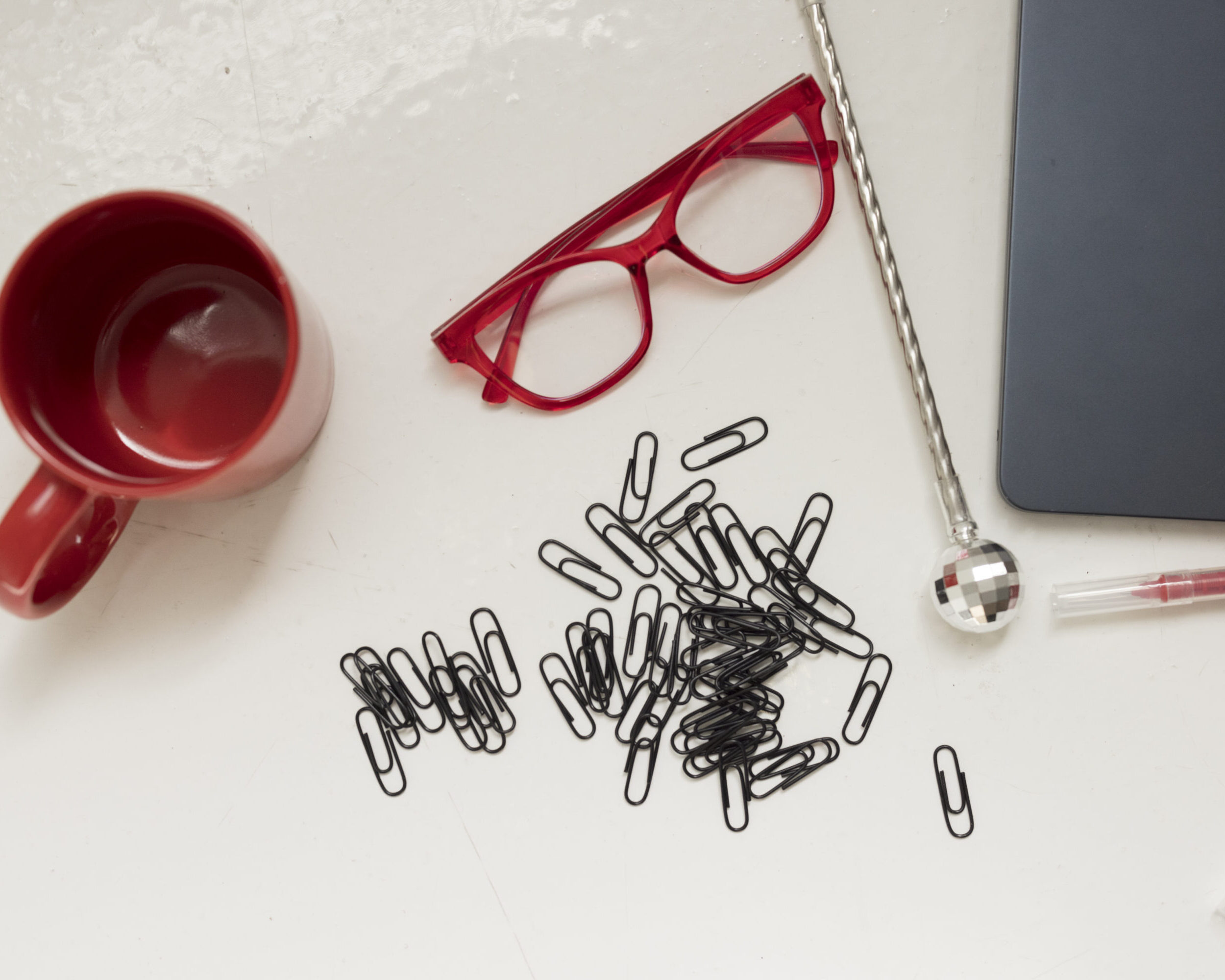office supplies and glasses laid across a desk
