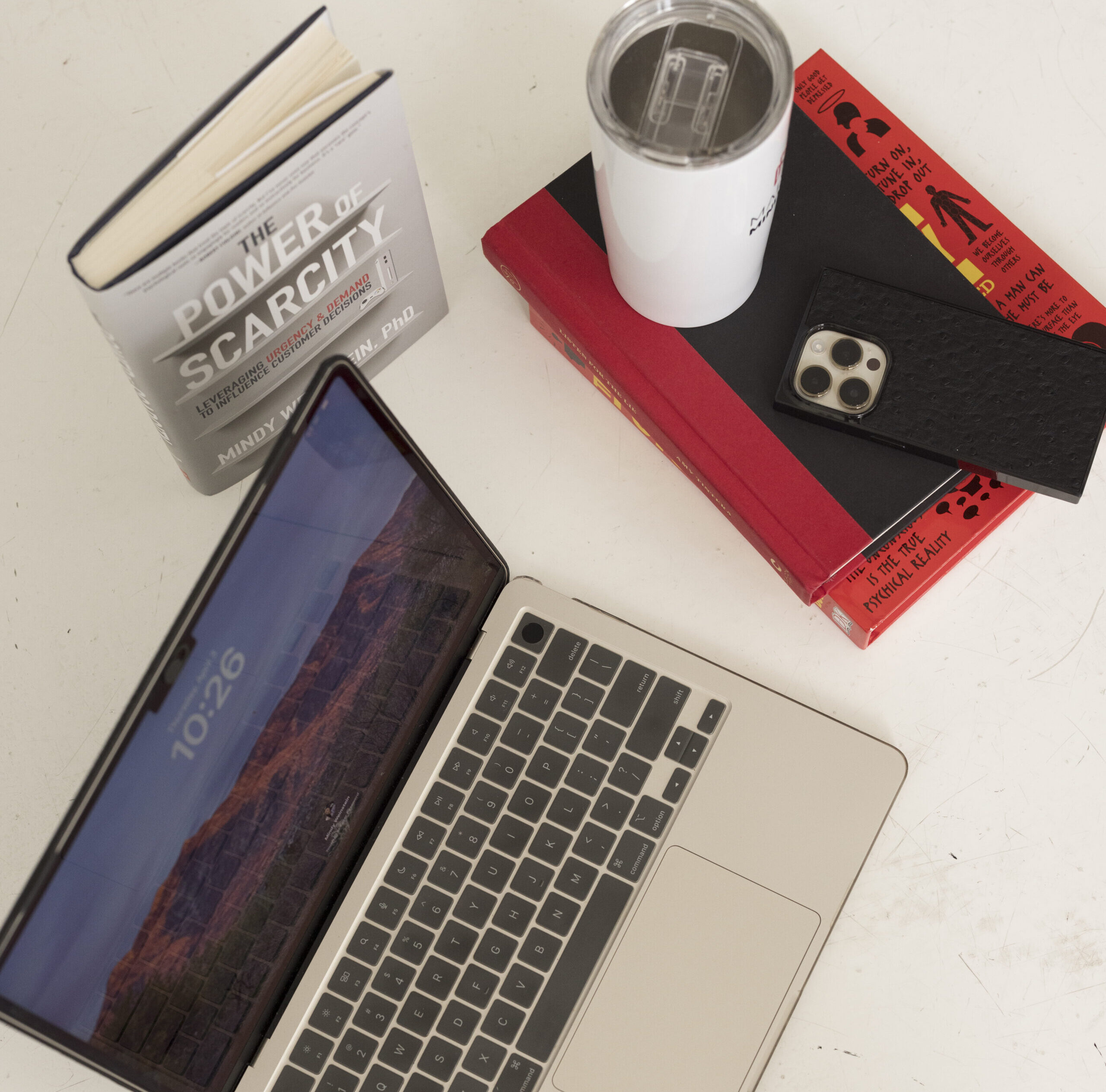 office materials, phone, book, and cup sitting on the floor